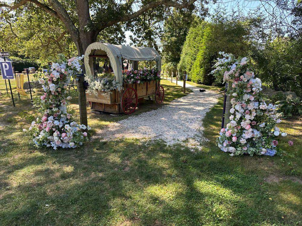 The farm's flower-covered welcome wagon at the start of the garden path, dressed for a wedding